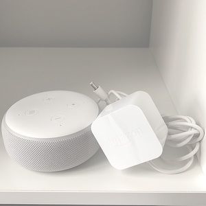 Amazon Echo Dot (Alexa) with charging cord.